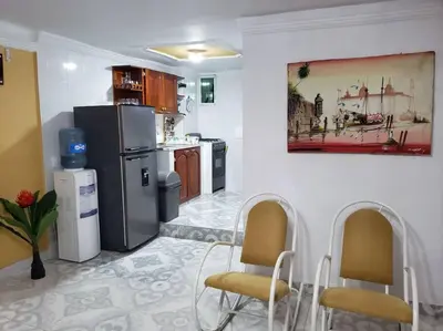 a kitchen with two chairs and a refrigerator at Apartamento en Centro Histórico De Cartagena in Cartagena de Indias