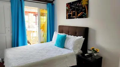 a bedroom with a bed with a blue window at Apartamento en Centro Histórico De Cartagena in Cartagena de Indias