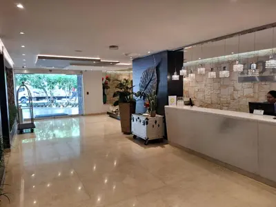 a lobby with a reception desk in a building at Washington Plaza in Barranquilla