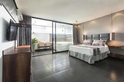 a bedroom with a bed and a television in it at Hotel Cartagena DC in Cartagena de Indias