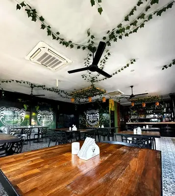 a dining room with a wooden table in a restaurant at Hotel Cartagena DC in Cartagena de Indias