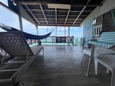a room with a hammock and the ocean at AcapulcoBeach in Playa Blanca