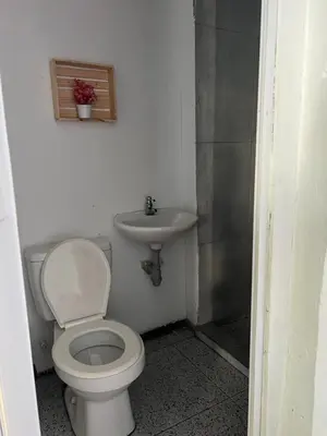 a bathroom with a toilet and a sink at AcapulcoBeach in Playa Blanca