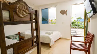 a bedroom with a bunk bed and a bed at CASA PLAYA JAMES in La Boquilla