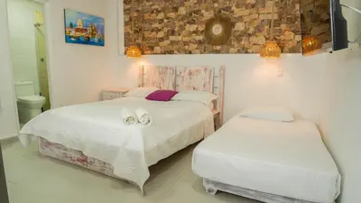 a bedroom with two beds with towels on them at CASA PLAYA JAMES in La Boquilla