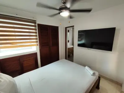 a bedroom with a bed and a ceiling fan at APARTAMENTOS LOS MANGLARES marbella in Cartagena de Indias