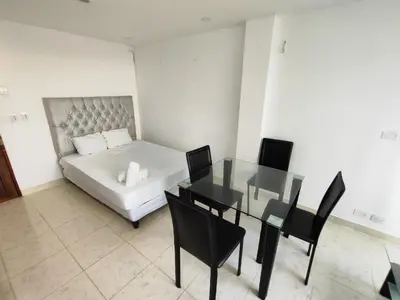 a bedroom with a bed and a table and chairs at APARTAMENTOS LOS MANGLARES marbella in Cartagena de Indias