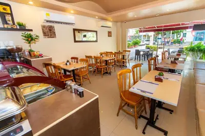 a dining room with tables and chairs in a restaurant at Azuán Suites Hotel By GEH Suites in Cartagena de Indias