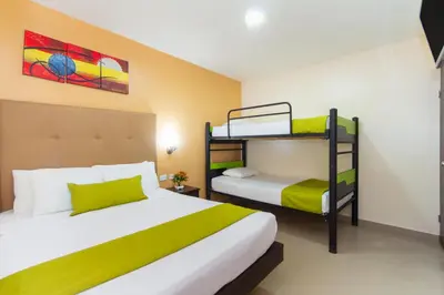 a bedroom with two bunk beds in it at Azuán Suites Hotel By GEH Suites in Cartagena de Indias