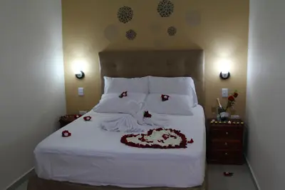 a bedroom with a white bed with a cake on it at Azuán Suites Hotel By GEH Suites in Cartagena de Indias