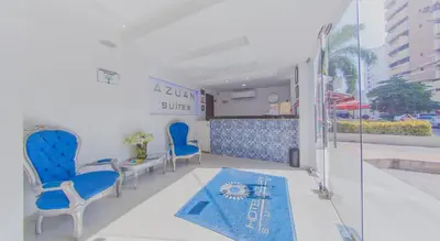 a waiting room with blue chairs and a blue rug at Azuán Suites Hotel By GEH Suites in Cartagena de Indias