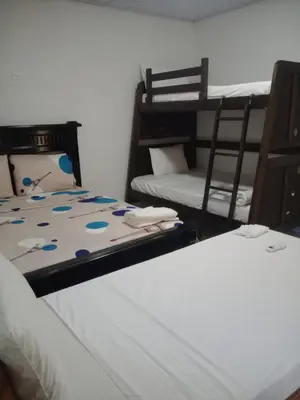 two beds in a room with two bunk beds at Hostal torres del caribe in San Bernardo del Viento