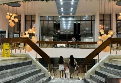 two girls walking down the stairs in a building at El Conquistador in Cartagena de Indias