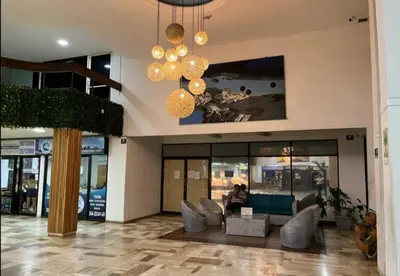 a lobby with couches and a chandelier in a building at El Conquistador in Cartagena de Indias