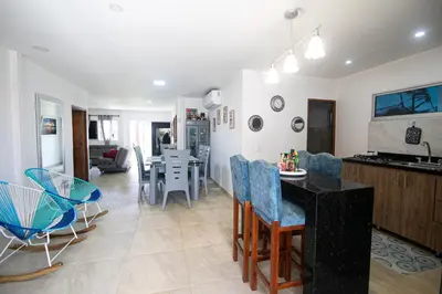 a kitchen and living room with a table and chairs at Casa Bita Morales CASA 101 in Las Canoas