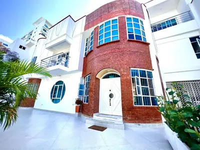 a red brick building with a white door at Charme 64 Hotel Boutique in Cartagena de Indias