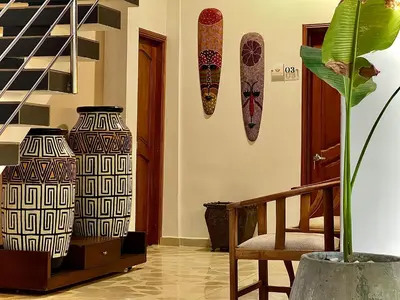 a room with two vases and a chair and a plant at Charme 64 Hotel Boutique in Cartagena de Indias