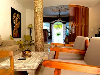 a living room with couches and a table and chairs at Charme 64 Hotel Boutique in Cartagena de Indias