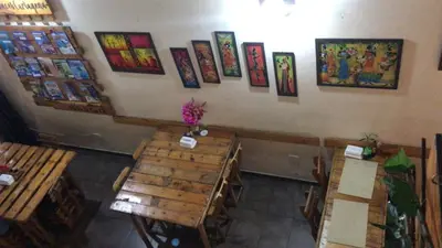 an overhead view of a restaurant with tables and pictures on the wall at Casa Hostal La Vie en Rose in Cartagena de Indias