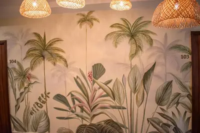 a mural of palm trees on a wall at Casa Noa Colonial Rooms in Cartagena de Indias