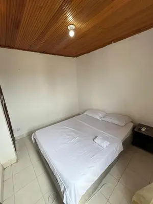 a bedroom with a white bed with a wooden ceiling at Apartamento VIVAMAR Manantial in Cartagena de Indias