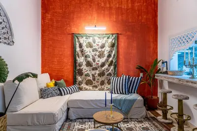 a living room with a couch and a red wall at Edificio Ayos dentro la ciudad amurallada in Cartagena de Indias