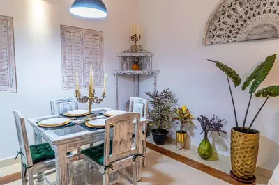 a dining room with a table and chairs and plants at Edificio Ayos dentro la ciudad amurallada in Cartagena de Indias