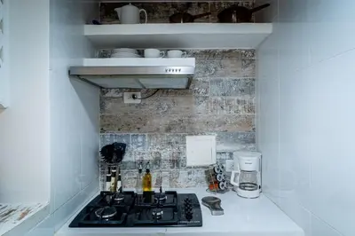 a small kitchen with a stove and a sink at Edificio Ayos dentro la ciudad amurallada in Cartagena de Indias