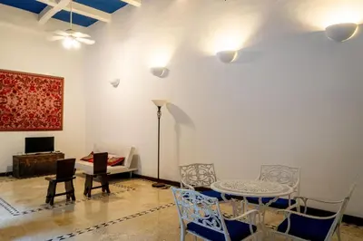 a living room with a table and chairs at Edificio Ayos dentro la ciudad amurallada in Cartagena de Indias