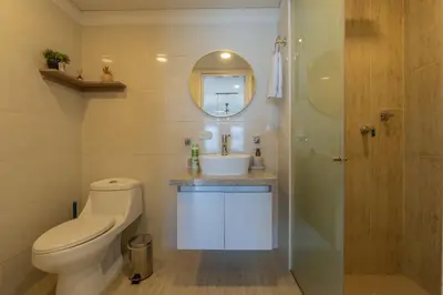 a bathroom with a toilet and a sink and a shower at Condominio exclusivo nuevo frente al mar Cartagena Beach in Cartagena de Indias