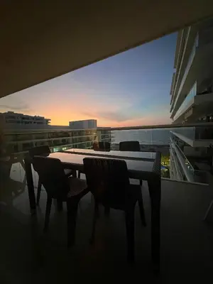 a table and chairs on a balcony with a view at Condominio frente al mar con acceso directo a la playa Morros Ultra in Cartagena de Indias