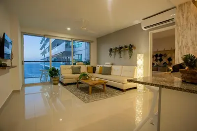 a living room with a couch and a table at Condominio frente al mar con acceso directo a la playa Morros Ultra in Cartagena de Indias