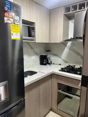 a kitchen with a stainless steel refrigerator and a sink at APARTAMENTO NUEVo in Cartagena de Indias