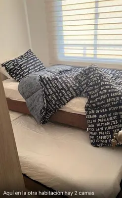 a bed with pillows on top of it at APARTAMENTO NUEVo in Cartagena de Indias