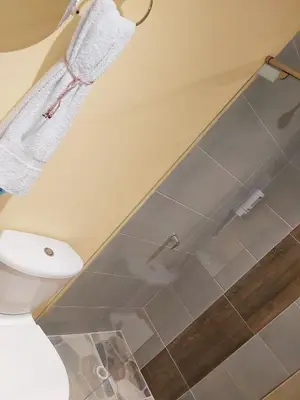 a bathroom with a toilet and a glass shower stall at Dreimar Hotel Boutique in Cartagena de Indias