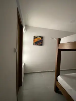 a bedroom with a bed and a painting on the wall at Apartamento Villa Mary-Coveñas in Coveñas