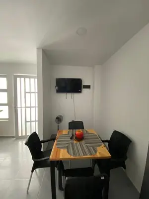 a dining room with a wooden table and chairs at Apartamento Villa Mary-Coveñas in Coveñas