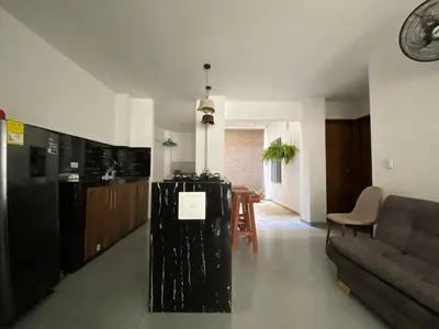a living room with a black refrigerator and a couch at Apartamento Villa Mary-Coveñas in Coveñas