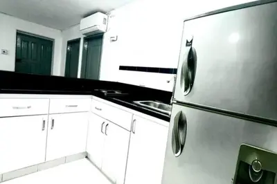 a kitchen with a stainless steel refrigerator and a sink at Apartamento Edificio los Delfines Bocagrande , ubicación y precio in Cartagena de Indias