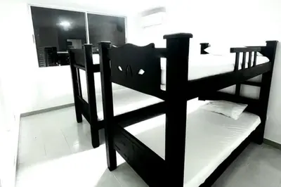 a black bunk bed in a room with a mirror at Apartamento Edificio los Delfines Bocagrande , ubicación y precio in Cartagena de Indias