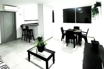 a living room with a table and a dining room at Apartamento Edificio los Delfines Bocagrande , ubicación y precio in Cartagena de Indias