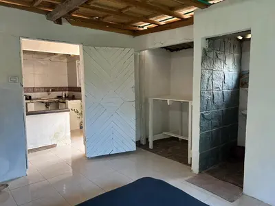 a kitchen being remodeled with a door in a room at Punta Arena EcoHostal & EcoFit - Your Eco-Friendly Oasis 01 in Playa Punta Arena