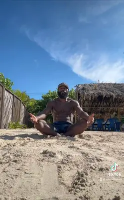 a man sitting on the beach doing meditation at Punta Arena EcoHostal & EcoFit - Your Eco-Friendly Oasis 02 in Playa Punta Arena