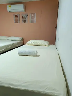 two twin beds in a room with a heater at Casa perla in Cartagena de Indias