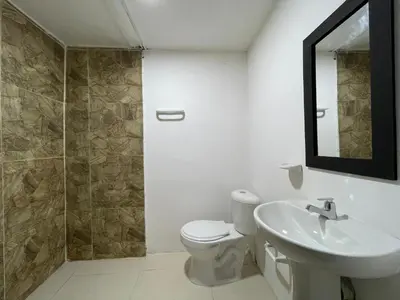 a bathroom with a toilet and a sink and a mirror at Casa perla in Cartagena de Indias