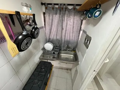 a tiny kitchen with a sink and a window at Belcanto Room's in Cartagena de Indias