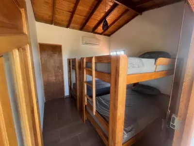 a room with two bunk beds and a hallway at Cabaña El Cangrejo Azul - Blue Crab House in San Onofre