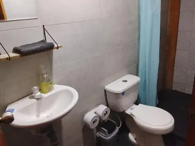 a bathroom with a toilet and a sink at Cabaña El Cangrejo Azul - Blue Crab House in San Onofre