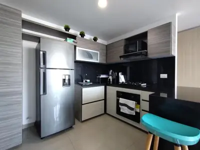 a kitchen with a stainless steel refrigerator and cabinets at Acogedor apartamento en exclusivo barrio de Barranquilla BUENAVISTA - SUNSET VIEW in Barranquilla