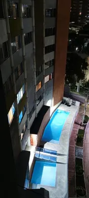 a swimming pool in front of a building at Acogedor apartamento en exclusivo barrio de Barranquilla BUENAVISTA - SUNSET VIEW in Barranquilla